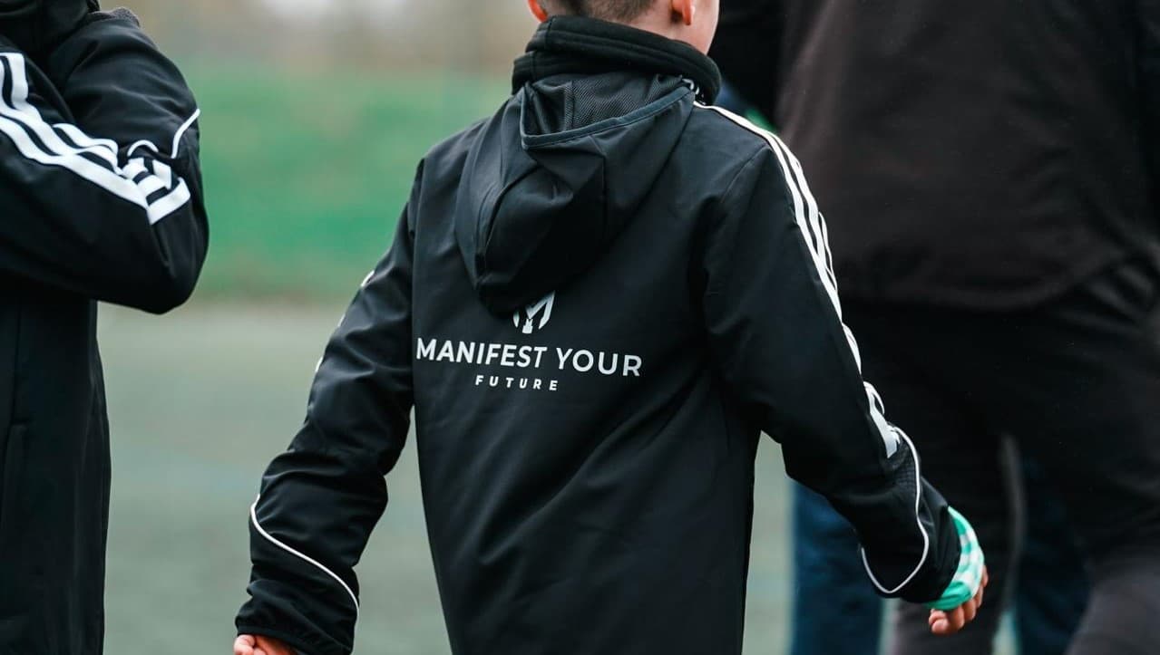Players wearing MYF kit on the pitch